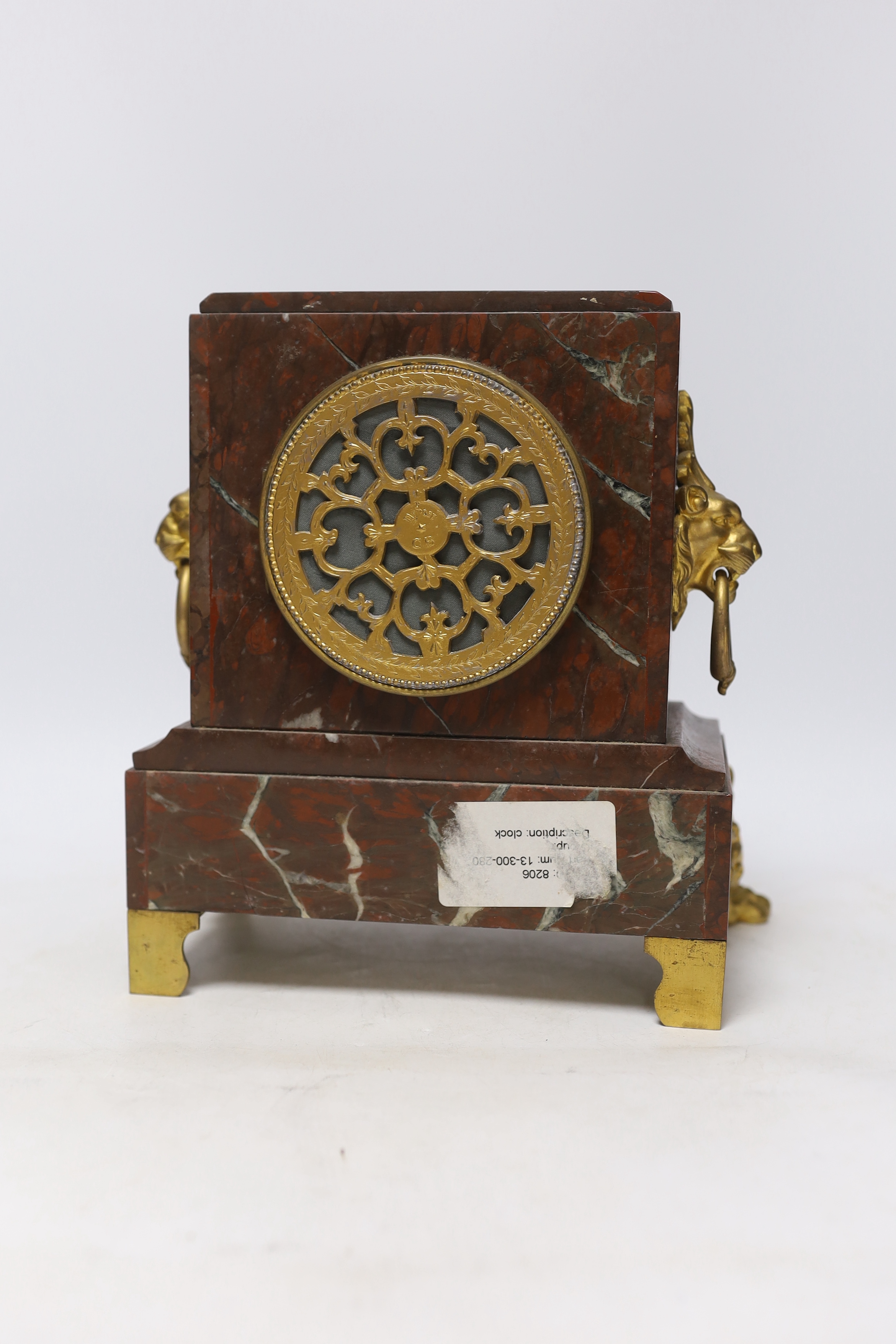 A late 19th century French rouge marble and ormolu clock garniture, 31cm